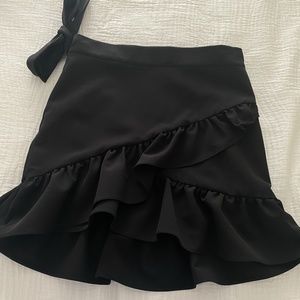 Black ruffle skirt with tie bow at waist